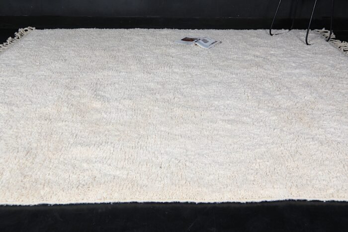 This unique Ivory Moroccan rug with Plain field is an essential element for any home, be it a fancy urban studio, a ranch log house, or a cozy family home in a small town