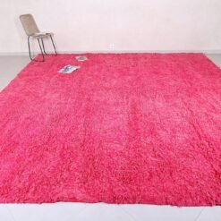 Right side of rose pink Moroccan rug made from 100% natural wool.