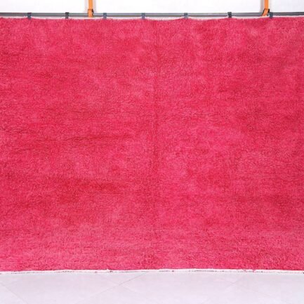 Handmade Moroccan rose pink wool rug with soft Beni Ourain texture.
