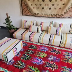 Side view of ivory base Moroccan floor cushion with bright embroidery