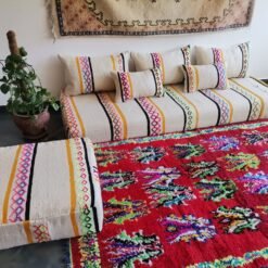 Artisan weaving vibrant embroidered wool fabric for Moroccan cushions