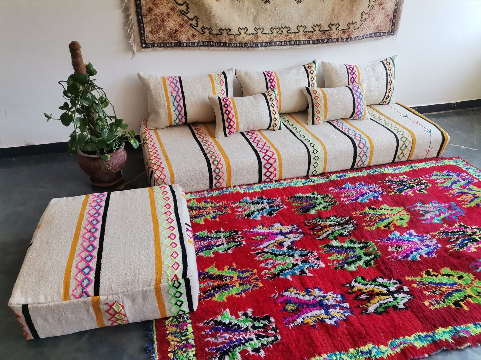 Artisan weaving vibrant embroidered wool fabric for Moroccan cushions