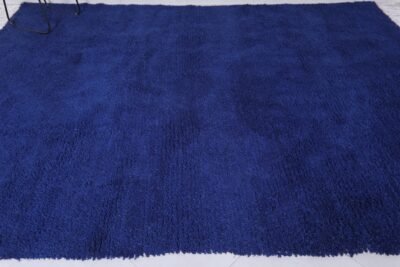 Moroccan royal blue Beni Ourain rug, showcasing detailed weaving, soft wool texture, and vibrant blue hue in a traditional design.