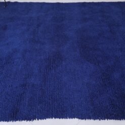 Moroccan royal blue Beni Ourain rug, showcasing detailed weaving, soft wool texture, and vibrant blue hue in a traditional design.