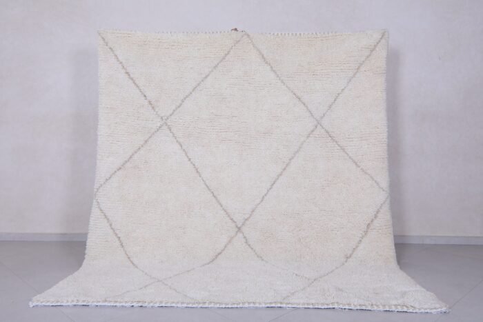 Handmade Moroccan rug with crisp white base and delicate tan trellis pattern, woven from 100% natural lamb wool by skilled Berber artisans in Morocco.