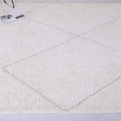 custom-sized white and tan Moroccan rug, emphasizing soft wool pile and elegant geometric design.