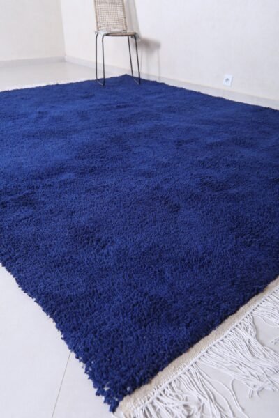 Moroccan royal blue wool rug featuring traditional Berber weaving and rich blue color, hand-crafted by Moroccan artisans.
