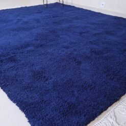 Moroccan royal blue wool rug featuring traditional Berber weaving and rich blue color, hand-crafted by Moroccan artisans.