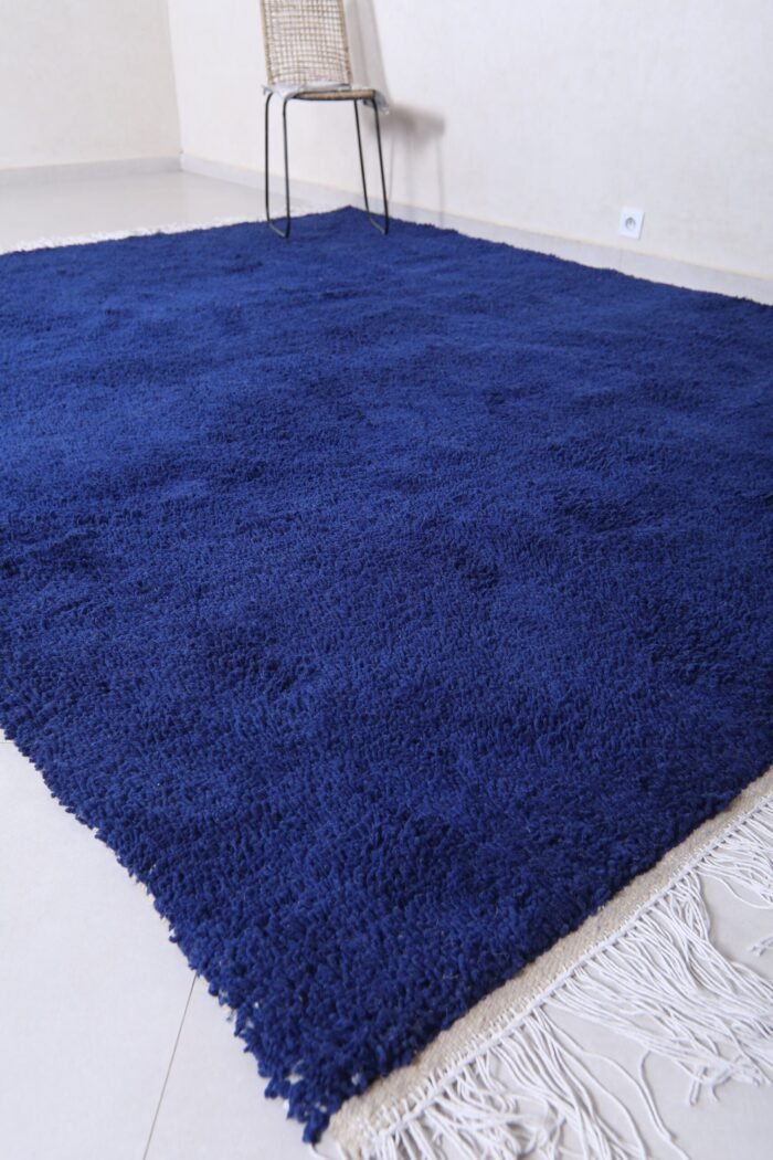 Moroccan royal blue wool rug featuring traditional Berber weaving and rich blue color, hand-crafted by Moroccan artisans.