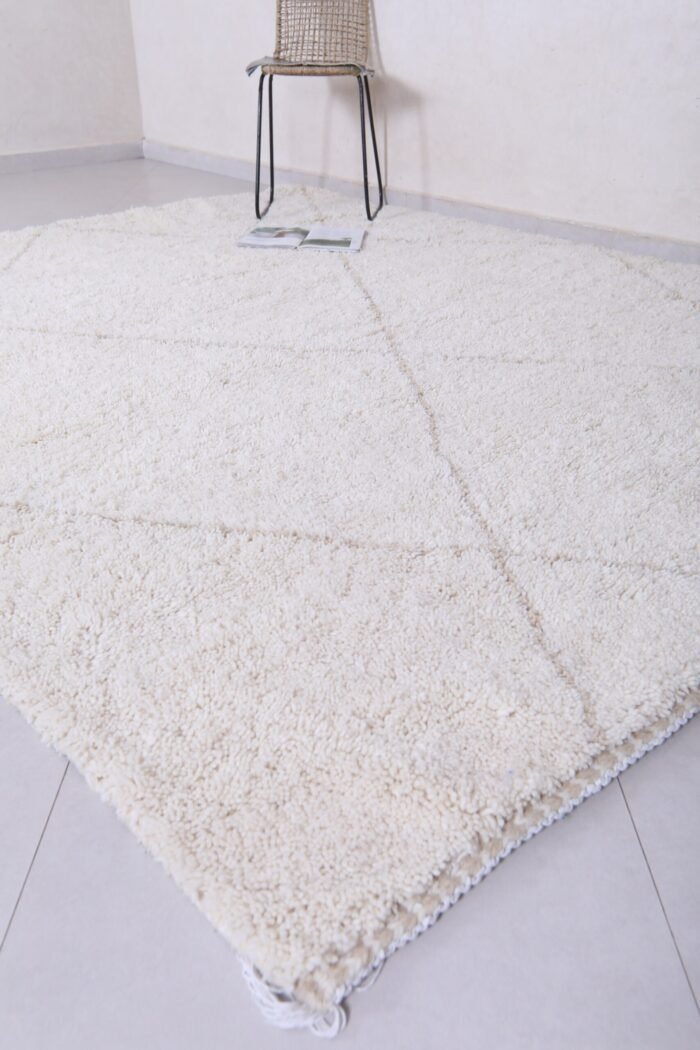 hand-knotted fringe on white and tan Moroccan rug, showcasing authentic artisan finishing techniques.