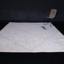 Moroccan wool rug in white with tan trellis design, illustrating quality weaving and thick, plush pile.