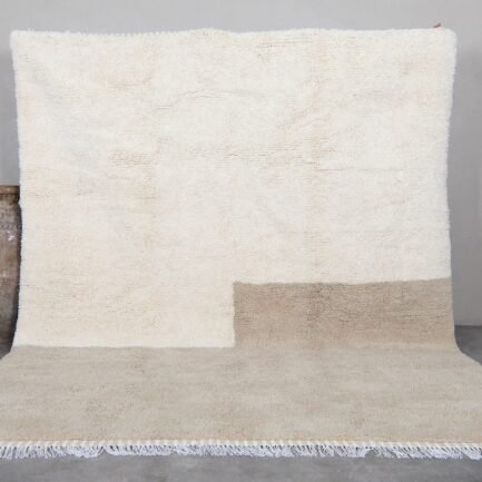 Contemporary Moroccan rug in elegant ivory and taupe tones, hand-knotted by Berber artisans using 100% natural lamb wool, perfect for modern and minimalist interiors.