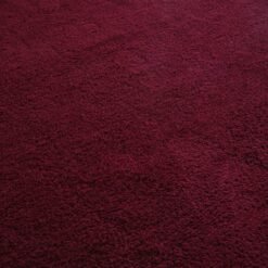 Moroccan burgundy wool rug, featuring artisan knotting and traditional fringes—crafted in the Atlas Mountains with care and authentic Berber tradition.