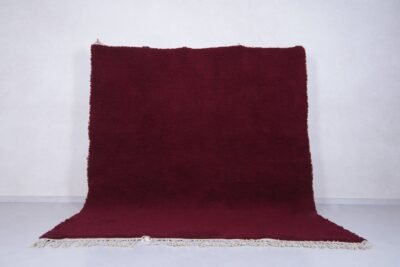 deep burgundy Moroccan area rug, showcasing handwoven wool texture and artisan Berber craftsmanship, perfect for elegant living rooms or custom-designed bedrooms.