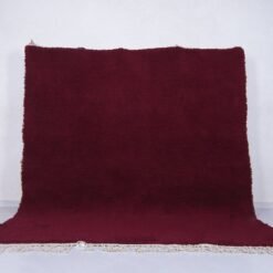 deep burgundy Moroccan area rug, showcasing handwoven wool texture and artisan Berber craftsmanship, perfect for elegant living rooms or custom-designed bedrooms.