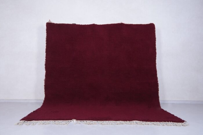 deep burgundy Moroccan area rug, showcasing handwoven wool texture and artisan Berber craftsmanship, perfect for elegant living rooms or custom-designed bedrooms.