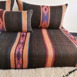 embroidered stripes on black and orange wool cushion fabric