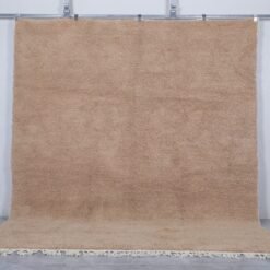 custom Beni Ourain Moroccan rug in soft sand brown color, hand-knotted from natural lamb wool by Berber artisans in the Atlas Mountains.