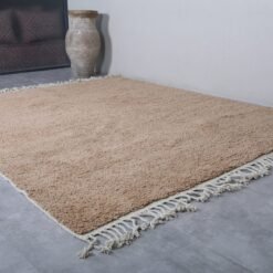 Moroccan handmade rug in sand brown wool, showing thick pile texture and soft Berber weaving. Ideal for boho, Japandi, or rustic interiors