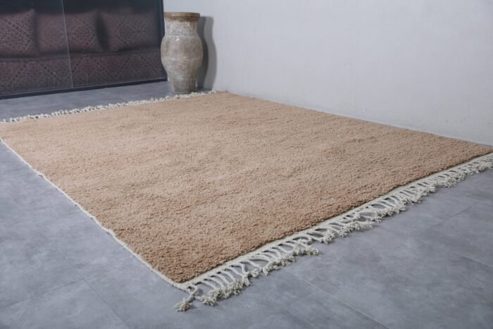 Moroccan handmade rug in sand brown wool, showing thick pile texture and soft Berber weaving. Ideal for boho, Japandi, or rustic interiors
