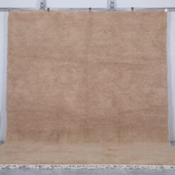 Authentic Moroccan sand brown Beni Ourain rug, handcrafted using 100% natural lamb wool. The soft earth-toned color blends beautifully with rustic, minimalist, and modern decor styles, perfect for living rooms or bedrooms.