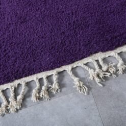 Fringe detail of handmade Moroccan royal purple wool rug.