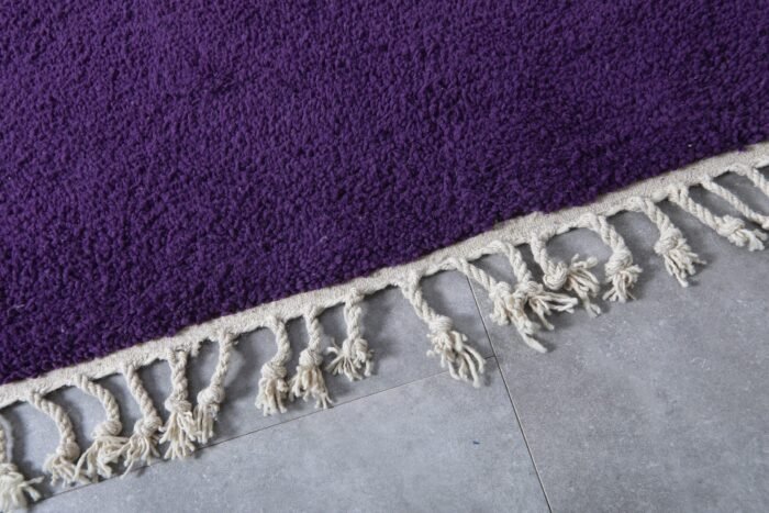 Fringe detail of handmade Moroccan royal purple wool rug.