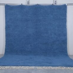 Authentic handmade Moroccan Beni Ourain rug in solid teal blue, crafted with natural lamb’s wool by skilled Berber artisans. A bold and calming wool rug perfect for modern and coastal interiors.