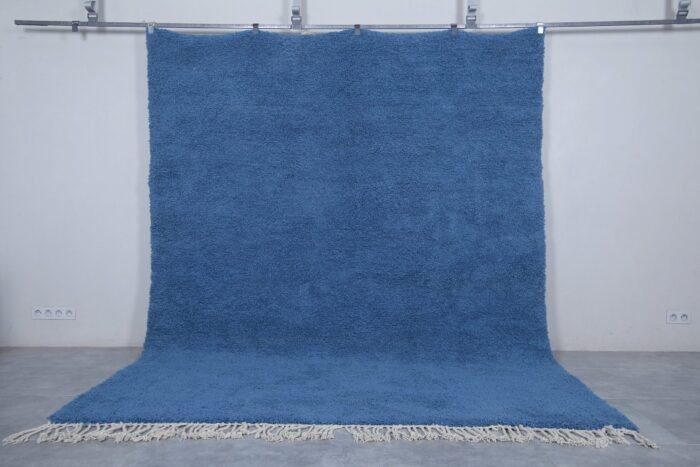 Authentic handmade Moroccan Beni Ourain rug in solid teal blue, crafted with natural lamb’s wool by skilled Berber artisans. A bold and calming wool rug perfect for modern and coastal interiors.