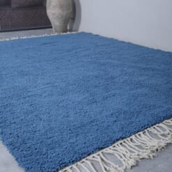 Handmade teal Moroccan wool rug, highlighting thick pile and vibrant color. Expertly woven by Berber women using traditional techniques.