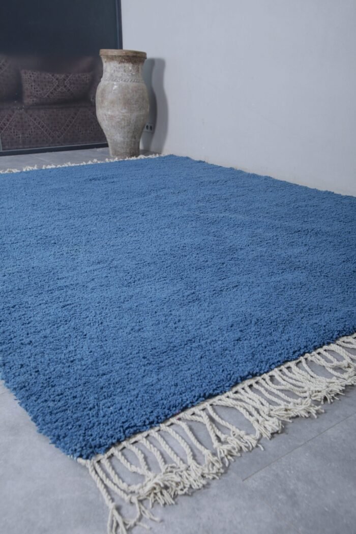 Handmade teal Moroccan wool rug, highlighting thick pile and vibrant color. Expertly woven by Berber women using traditional techniques.