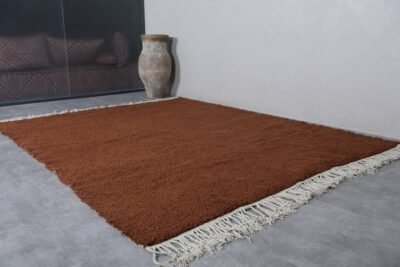fringe on handmade Moroccan dark brown wool rug, showing artisanal finishing.