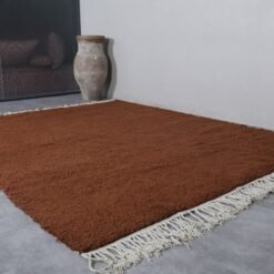 fringe on handmade Moroccan dark brown wool rug, showing artisanal finishing.