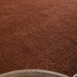 Moroccan dark brown Beni Ourain rug highlighting dense wool fibers.
