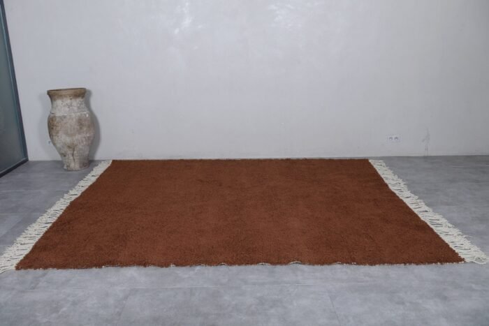 handcrafted Moroccan dark brown wool rug with tribal Berber patterns.