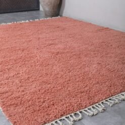 Fringe detail of Moroccan blush pink wool rug with artisanal Berber finish.