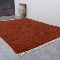 warm terracotta Moroccan rug, hand-knotted with natural wool by skilled Berber women artisans, customizable fringe length upon request.