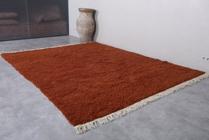 warm terracotta Moroccan rug, hand-knotted with natural wool by skilled Berber women artisans, customizable fringe length upon request.