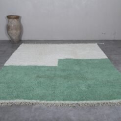 custom Moroccan rug in ivory and green, emphasizing its minimalist style and plush, high-pile finish.