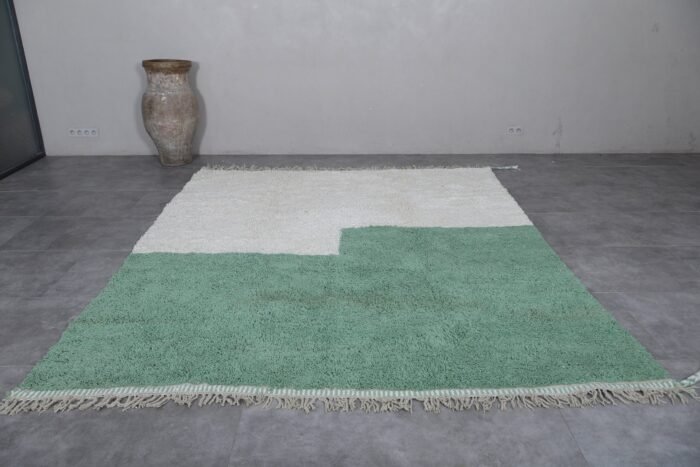 custom Moroccan rug in ivory and green, emphasizing its minimalist style and plush, high-pile finish.