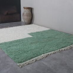 ivory Moroccan wool rug with fresh green detailing, showcasing its thick, soft texture and hand-knotted craftsmanship.