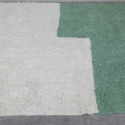hand-knotted Moroccan Beni Ourain rug in ivory and green, showing its density, thickness, and quality wool construction.