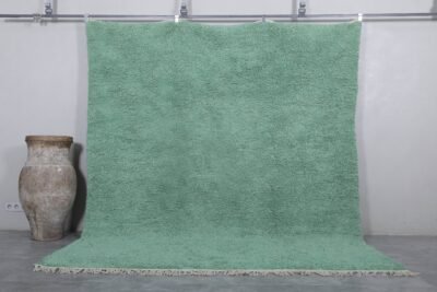 Handmade Moroccan Berber rug in mint green, crafted from 100% natural wool with a soft, minimalist design. This custom Beni Ourain rug blends traditional craftsmanship with a fresh modern color, perfect for boho interiors, cozy bedrooms, or calm living spaces.