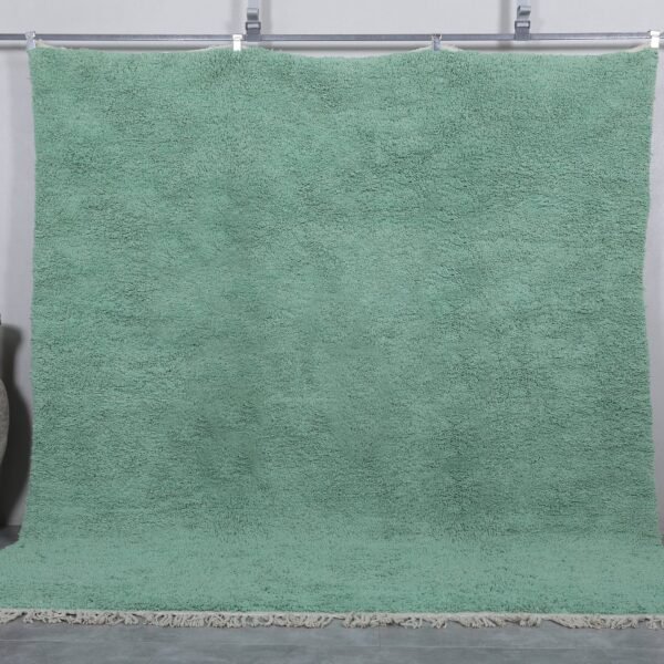 Handmade Moroccan Berber rug in mint green, crafted from 100% natural wool with a soft, minimalist design. This custom Beni Ourain rug blends traditional craftsmanship with a fresh modern color, perfect for boho interiors, cozy bedrooms, or calm living spaces.