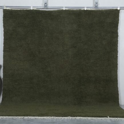 Handmade Moroccan Dark Green Berber Rug crafted from 100% natural wool, featuring a deep green solid color and traditional Beni Ourain weave—perfect for living rooms, bedrooms, or minimalist interiors