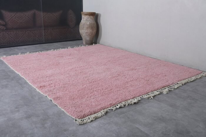 handcrafted millennial pink Moroccan rug showing its natural wool texture, clean solid color, and elegant artisan quality ideal for boho-chic or modern decor.
