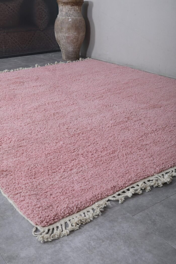 millennial pink Moroccan rug's soft wool fibers, rich handmade details, and subtle texture, woven with care by Berber women in the Atlas Mountains.
