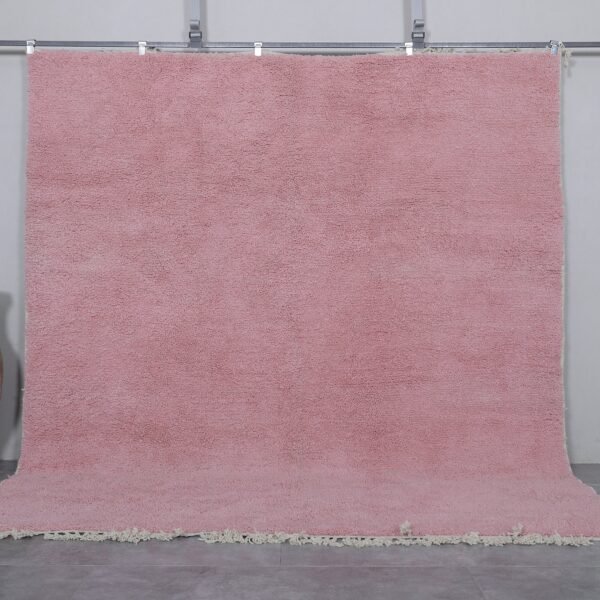 Authentic handmade Moroccan millennial pink rug, crafted from 100% natural wool using traditional Beni Ourain weaving. This soft and elegant solid pink area rug is perfect for modern interiors, bedrooms, or boho living rooms.