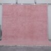 Authentic handmade Moroccan millennial pink rug, crafted from 100% natural wool using traditional Beni Ourain weaving. This soft and elegant solid pink area rug is perfect for modern interiors, bedrooms, or boho living rooms.