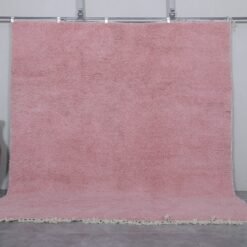 Authentic handmade Moroccan millennial pink rug, crafted from 100% natural wool using traditional Beni Ourain weaving. This soft and elegant solid pink area rug is perfect for modern interiors, bedrooms, or boho living rooms.